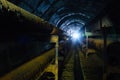 Round concrete underground tunnel of heating duct system with rusty pipes Royalty Free Stock Photo