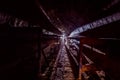 Round concrete underground tunnel of heating duct system with rusty pipes Royalty Free Stock Photo