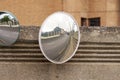 Round convex traffic safety mirror reflecting a street Royalty Free Stock Photo