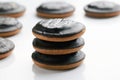 Round cookies covered in chocolate lie on top of each other on a white vertical background with copy space at the bottom. The Royalty Free Stock Photo
