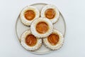 Round cookies with fruit jam and icing sugar, italian occhi di bue, isolated on white