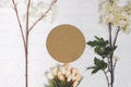 Round cork board and flowers on white brick background. Royalty Free Stock Photo