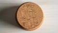 Round cork coaster featuring a textured mosaic pattern on its surface Royalty Free Stock Photo
