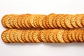 Round crackers in perfect alignment, showcased against a white background Royalty Free Stock Photo