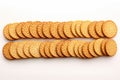 Round crackers in perfect alignment, showcased against a white background Royalty Free Stock Photo