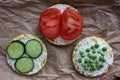 Round crispy corn sandwiches with vegetables toppings. Puffed corn cakes with cream cheese, tomatoes, cucumbers, and peas