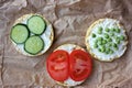 Round crispy corn sandwiches with vegetables toppings. Puffed corn cakes with cream cheese, tomatoes, cucumbers, and peas