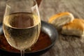 Round crystal glass with cold white wine. Rural rustic kitchen. Fermented grape juice Royalty Free Stock Photo