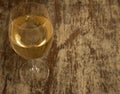 Round crystal glass with cold white wine. Rural rustic kitchen. Fermented grape juice