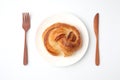 round danish bread on plate isolated on white background Royalty Free Stock Photo