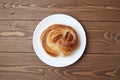 round danish bread on plate  on wooden table Royalty Free Stock Photo