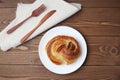 round danish bread on plate  on wooden table Royalty Free Stock Photo