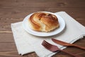 round danish bread on plate  on wooden table Royalty Free Stock Photo