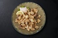 Round dish with fried squid with sauce and lemon wedge Royalty Free Stock Photo