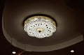 Round drop ceiling with lamps / lighting fixtures. Modern interior photo. Abstract architecture in shades of light gray / white co