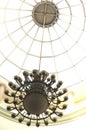 A round drop light with a golden chain hanging on a glass dome