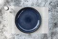 Round empty plate dark blue Placed on the table concrete black and White texture background Royalty Free Stock Photo