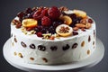 Round festive fruit cake with white cream and decoration of fresh berries
