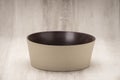 A Round, Flat Base Beige Soup Bowl with Brown Interior