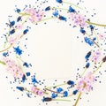 Round floral frame blue and pink flowers and card on white background. Flat lay, top view. Blog, social media or website backgroun