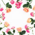 Round floral frame of roses, buds and green leaves on white background. Flat lay, top view. Spring background Royalty Free Stock Photo