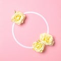 Round floral frame with roses flowers petals on pastel pink background. Top view, tender minimal flat lay style composition. Royalty Free Stock Photo