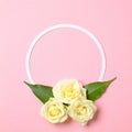 Round floral frame with roses flowers petals on pastel pink background. Top view, tender minimal flat lay style composition. Royalty Free Stock Photo