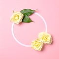 Round floral frame with roses flowers petals on pastel pink background. Top view, tender minimal flat lay style composition. Royalty Free Stock Photo