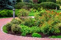 A round flower bed with a lot of different plants.