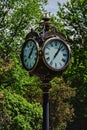 Round four faced outdoor clock in Cismigiu Park in Bucharest