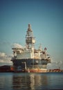 Round FPSO berthing at port with blue sky