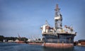 Round FPSO berthing at port with blue sky