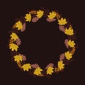 Round frame from autumn leaves and berries on a dark brown background Royalty Free Stock Photo