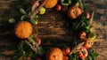 Round frame made of autumn vegetables and fruits on wooden background. Royalty Free Stock Photo