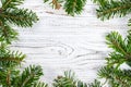 Round frame made of Christmas pine tree branches on old wooden board. Space for text. Top view Royalty Free Stock Photo