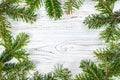 Round frame made of Christmas pine tree branches on old wooden board. Space for text. Top view Royalty Free Stock Photo