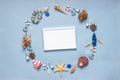 Round frame made of decorative items and miniature toys: seashells, seastars, vessel, boat, anchors, steering wheels, life buoys. Royalty Free Stock Photo