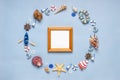 Round frame made of decorative items and miniature toys: seashells, seastars, vessel, boat, anchors, steering wheels, life buoys. Royalty Free Stock Photo