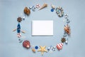 Round frame made of decorative items and miniature toys: seashells, seastars, vessel, boat, anchors, steering wheels, life buoys. Royalty Free Stock Photo