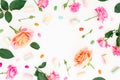 Round frame of Roses flowers and marshmallow with colorful candy on white background. Flat lay, top view. Royalty Free Stock Photo