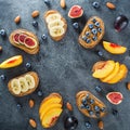 Round frame of sandwich with peanut butter, fresh fruits and berries. Flat lay, top view Royalty Free Stock Photo