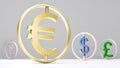 Round-framed gold-plated euro symbol dominates other currency symbols against a neutral gray background with room for text or logo Royalty Free Stock Photo