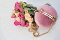 Round gently pink clutch and bridal bouquet of white and pink roses on a white background. Royalty Free Stock Photo