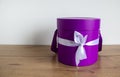 Round gift box on a wooden table on a white background. Copy space Royalty Free Stock Photo