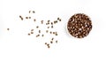 In a round glass bowl are roasted Arabica beans. Light background