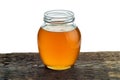 Round glass jar with fresh vegetable oil on the background of rough wood Royalty Free Stock Photo