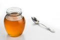 Round glass jar and spoon with fresh vegetable oil. Royalty Free Stock Photo