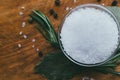 Round glass spice bowl on a wooden table - sea salt