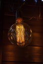 Round glowing tungsten lamp on a dark background