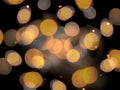 round golden coloured blurred lights with sparkles on a black background